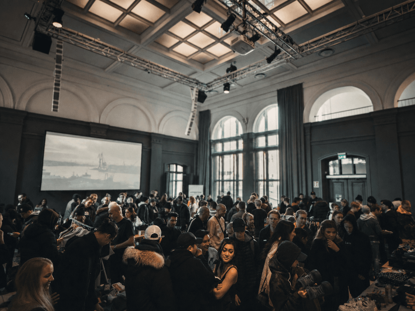Guests gathering in a grand venue for a corporate function