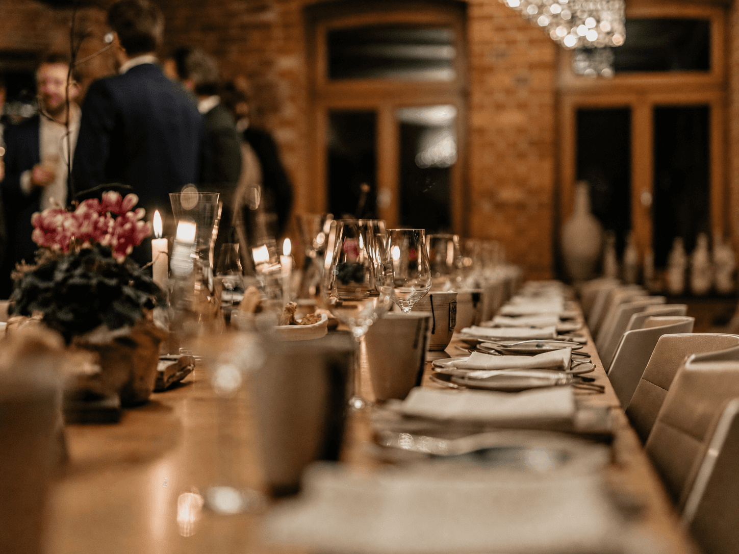 Candlelit dinner table set for an intimate private gathering