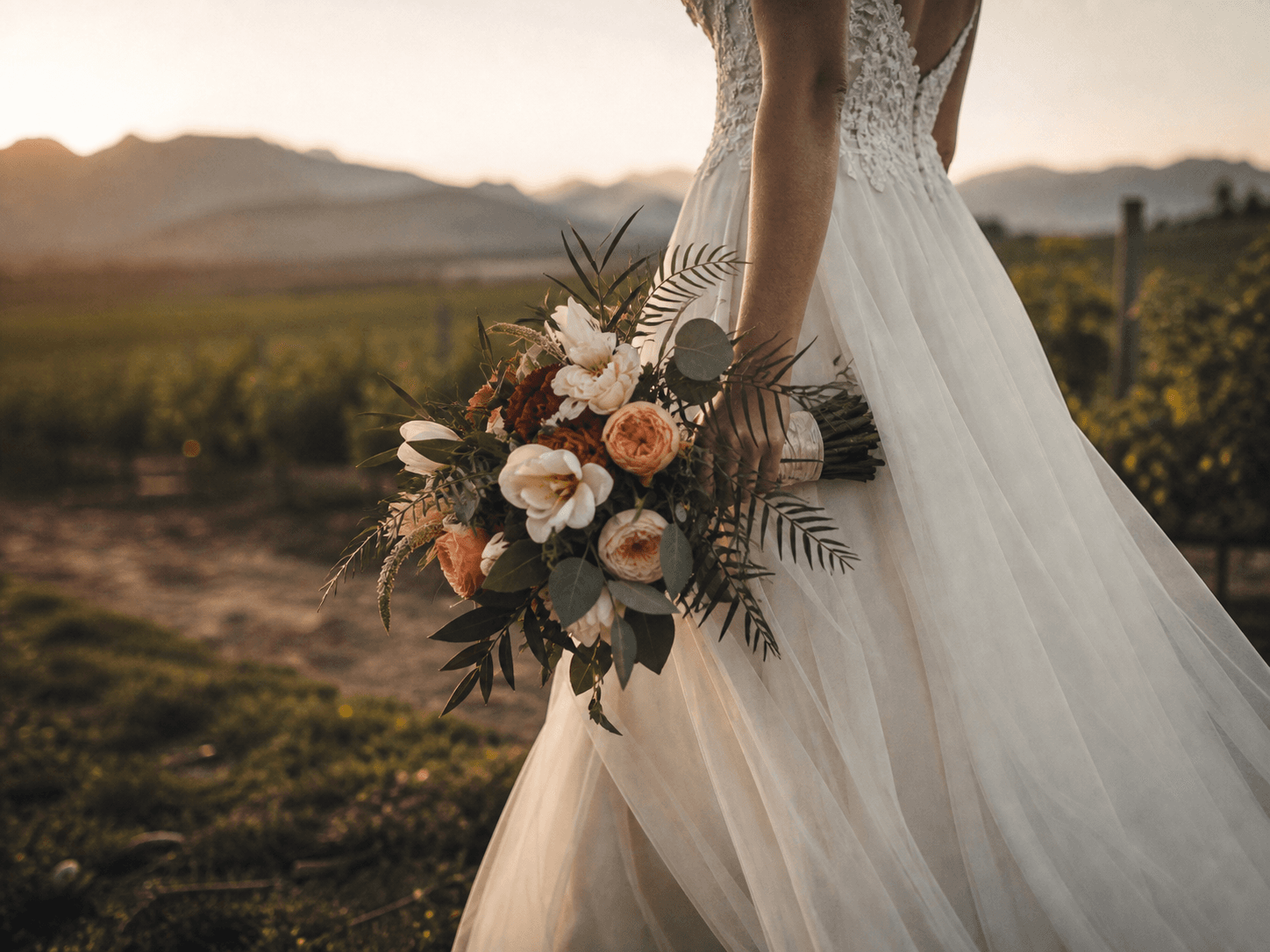 Wedding bouquet and ivory dress in a Cape Winelands vineyard